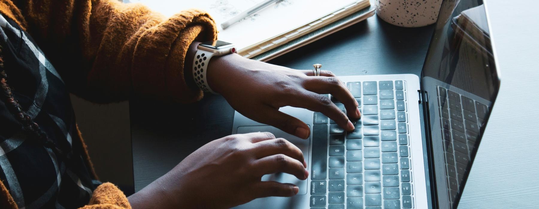 a person typing on a laptop
