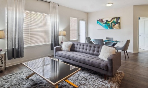 a spacious room with a couch and coffee table