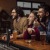 people laughing at a bar