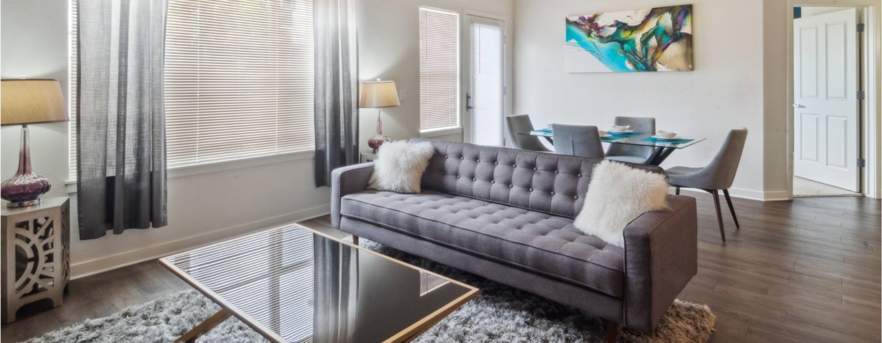 a spacious room with a couch and coffee table